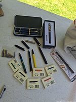 Overview showing pens, ink cartridge boxes, nibs and cases