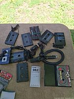 Overview of eight cassette adapters, Maxell 982 cleaner, and car power adapter