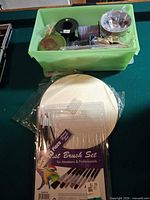 Bin with spools of wire, beads, wood shapes; brush set and wood circles visible