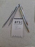 Group of four silver-tone Cross pens and pencil displayed together
