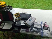 All items laid out on table showing SiriusXM kit, keyboard, Echo Dot, boxed 3D pen, camera, DVD player, RecZone, cables