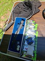 Overall lot showing landing net, fillet knife set, stacked sealed lures
