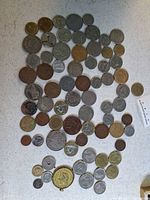 Overview of roughly 65 foreign coins laid out