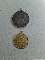 Both coin pendants laid flat
