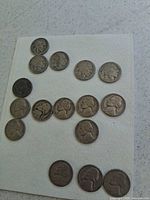 All 16 nickels laid out on white pad