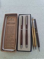 Hallmark boxed set with leaflet, additional Hallmark pen, Avon pen and pencil