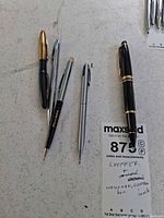 Group shot of five writing instruments on tabletop
