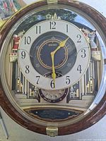 Front view of Seiko musical wall clock showing dial, bezel and decorative elements