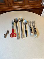 All seven utensils laid out on countertop