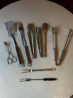 All nine barbecue utensils laid out