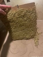 Front view of gold fringe wrapped on card