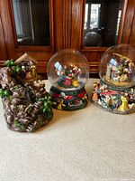 Three nativity items: two snow globes, one figurine