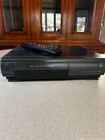 Front view of GE VCR with remote on top