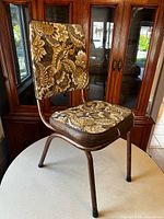 Front three-quarter view of floral vinyl chair