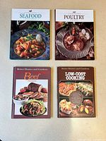 All four cookbooks laid out front covers visible