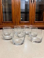 Front view of all eight clear lowball glasses showing thick bases