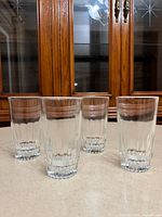 Four clear fluted tumblers front view