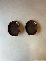 Front view of both matching wooden oval frames