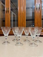 Six clear stemmed glasses front view