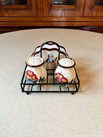 Salt & pepper shakers and napkin holder in black wire caddy