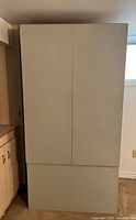 Front view of closed grey wardrobe