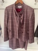 Front view of jacket over skirt showing overall suit design