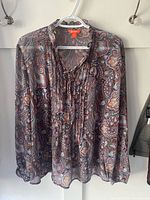 Front view of paisley chiffon blouse on hanger