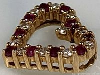 Front view of heart pendant showing alternating rubies and diamonds