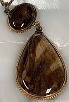 Close-up of teardrop and oval butterfly wing pendant