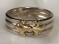 Front view showing gold fleur-de-lis on sterling shank