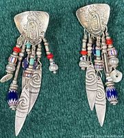 Front view of both sterling silver dangle earrings showing engravings and bead accents