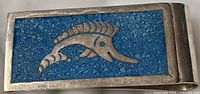 Front view showing blue lapis inlay and marlin design