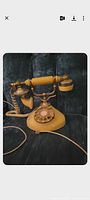 Front view of yellow antique-style rotary telephone