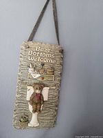 Full view of hanging bathroom sign on wall