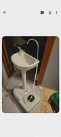 Full view of freestanding camping sink showing basin, faucet, soap dispenser and base