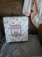 Front view of Mary Engelbreit At Home box containing teapot