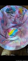Front view of pastel rainbow unicorn bean bag chair showing face, ears, mane and seat