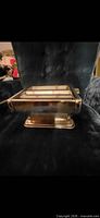 Front view of stainless steel pasta maker seated on chair