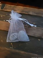Organza pouch containing grey stones, Yes stone visible
