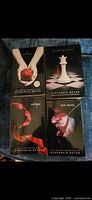 Front covers of the four Twilight Saga novels arranged on blue fabric