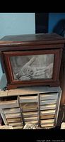 Front view of wooden photo box showing glass photo insert and overall shape