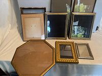 Front and back rows of assorted frames showing finishes, shapes and glass