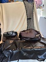 All items: vinyl protector spread out, organizer bag, folded seat covers, cargo net draped