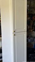 Cabinet closed, showing exterior finish and door knobs