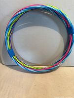 Stack of five multicolour plastic hula hoops taped together