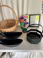 overall lot view showing wicker basket, planters, cups, craft pen box, frame, octagonal basket