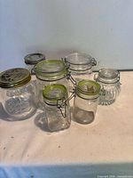 Group of glass lever-top and Mason jars displayed on surface
