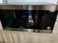 Front view of Galanz ExpressWave microwave showing door, controls, stainless trim