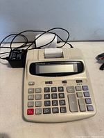 RadioShack printing calculator with attached adapter and paper roll