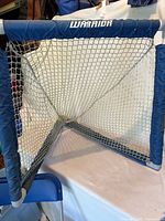 Front view of Warrior mini lacrosse/hockey net showing full frame and netting